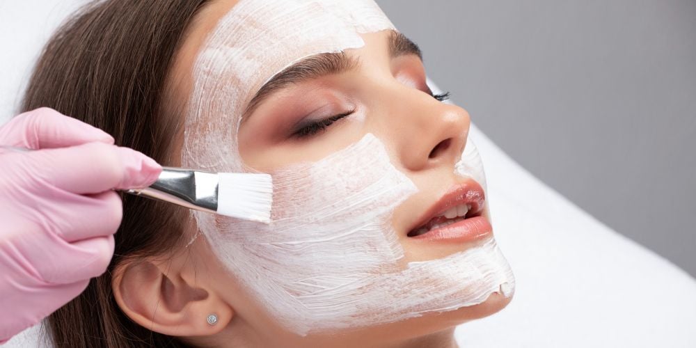 Woman receiving a facial at a local day spa.